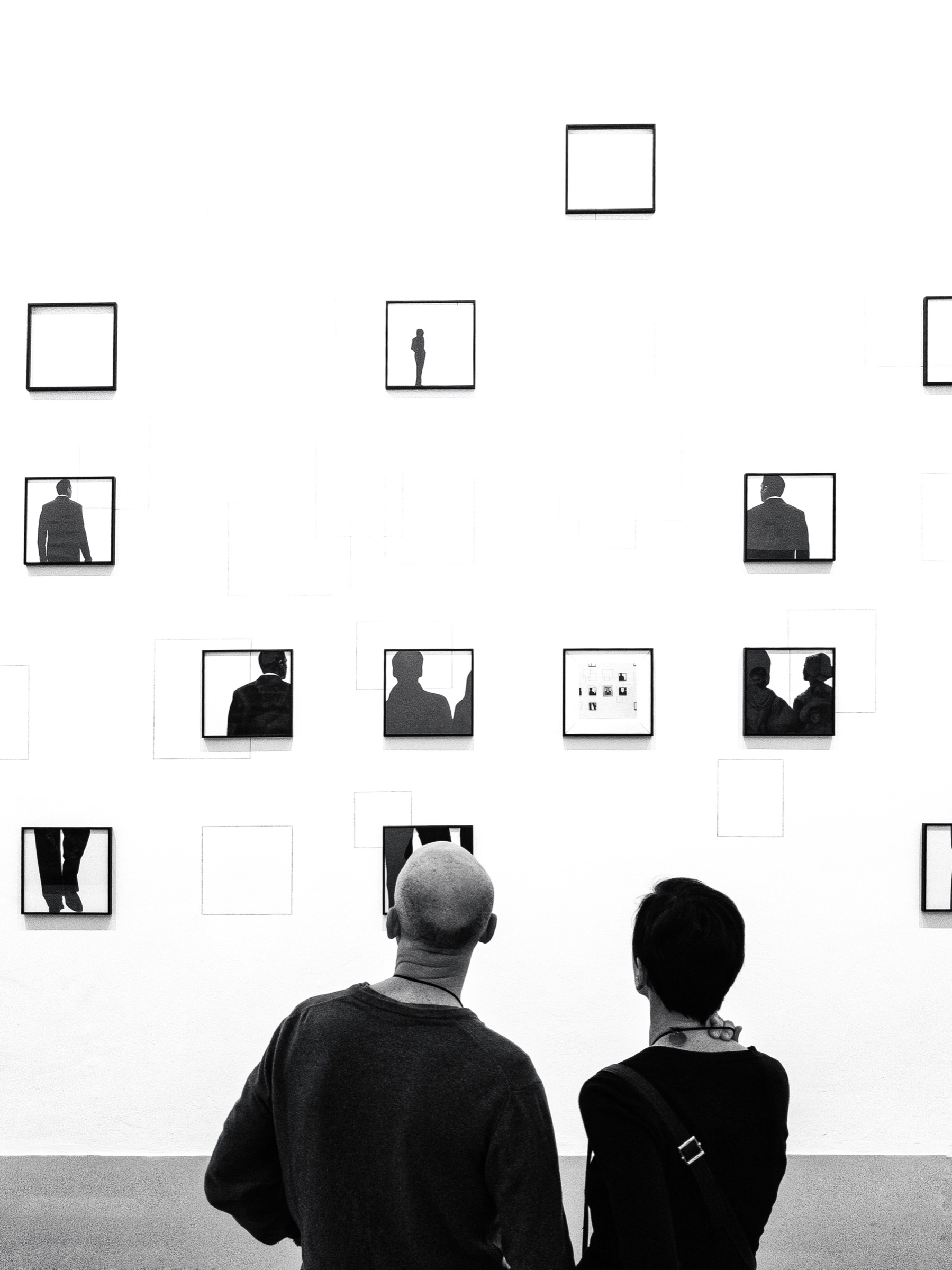 Two people looking at art in a gallery